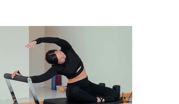 Patient performing a guided Clinical Pilates exercise on a reformer at Motion Pro Health in Burnaby.