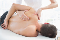 Chiropractic doctor performing Active Release Therapy to stretch out tensed muscle and help patient recover 